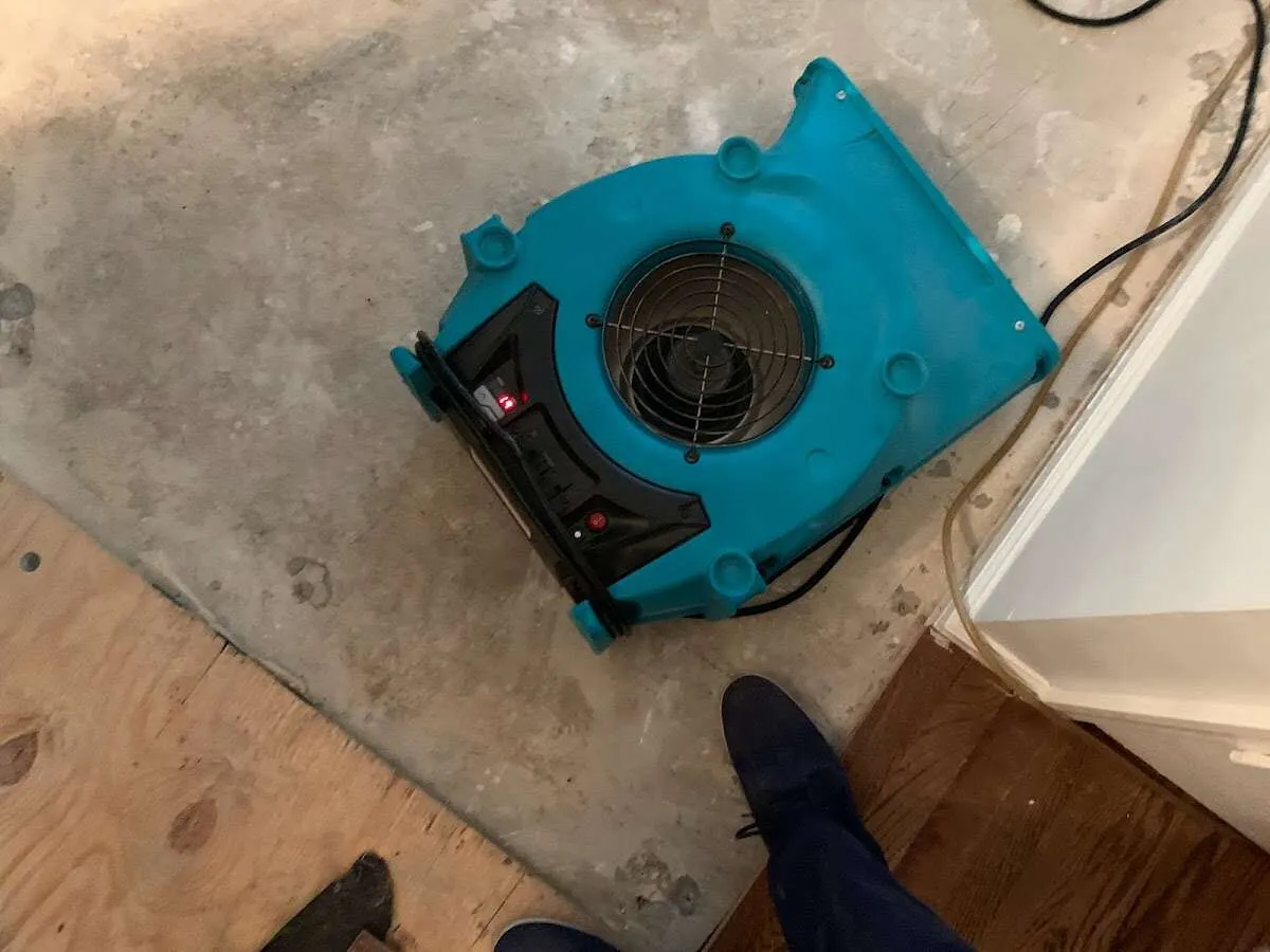 Air mover drying subfloor during Commercial Water Damage Restoration in Fort Stewart